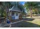 Charming backyard shed with a gray exterior and a wooden deck at 8448 Se 161St St, Summerfield, FL 34491