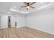 Light and airy bedroom with wood-look floors and shiplap accent wall at 8448 Se 161St St, Summerfield, FL 34491