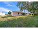 Large backyard with a screened patio and green lawn at 8478 Sw 60Th Ct, Ocala, FL 34476
