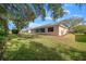 Pink house with screened porch and a large grassy backyard at 8478 Sw 60Th Ct, Ocala, FL 34476