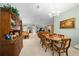 Bright dining room featuring a wood table and chairs, with a view into the living room at 8478 Sw 60Th Ct, Ocala, FL 34476