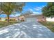 Pink house with a long driveway and spacious yard at 8478 Sw 60Th Ct, Ocala, FL 34476