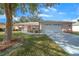 Single-story home with a white garage door and manicured lawn at 8478 Sw 60Th Ct, Ocala, FL 34476