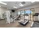 Well-equipped fitness center with various exercise machines and pool view at 8478 Sw 60Th Ct, Ocala, FL 34476