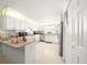 Galley style kitchen with white cabinets, stainless steel appliances, and an island at 8478 Sw 60Th Ct, Ocala, FL 34476
