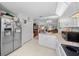 Kitchen area with stainless steel refrigerator and view into dining area at 8478 Sw 60Th Ct, Ocala, FL 34476