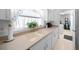 Kitchen features a double sink, light countertops, and laundry access at 8478 Sw 60Th Ct, Ocala, FL 34476