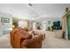 Spacious living room with vaulted ceiling, leather furniture, and large TV at 8478 Sw 60Th Ct, Ocala, FL 34476
