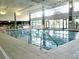 Indoor swimming pool with large windows at 9464 Se 132Nd Loop, Summerfield, FL 34491