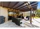 Patio with pergola, comfortable seating, and serene golf course view at 9551 Sw 70Th Loop, Ocala, FL 34481