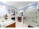 Bathroom with granite countertops, dual sinks, and walk in shower at 9551 Sw 70Th Loop, Ocala, FL 34481