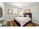 Bedroom with floral bedding, hardwood floors, and a ceiling fan at 9551 Sw 70Th Loop, Ocala, FL 34481