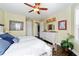 Bright bedroom with a queen bed, dresser, and hardwood floors at 9551 Sw 70Th Loop, Ocala, FL 34481