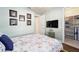 Bedroom with floral bedding, TV, and walk-in closet at 9551 Sw 70Th Loop, Ocala, FL 34481