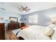 Bright bedroom featuring hardwood floors and plantation shutters at 9551 Sw 70Th Loop, Ocala, FL 34481