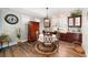 Bright dining room features a wooden table with chairs, built-in cabinetry, and hardwood floors at 9551 Sw 70Th Loop, Ocala, FL 34481