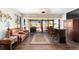 Relaxing Gathering room with leather seating, wet bar, and view of backyard at 9551 Sw 70Th Loop, Ocala, FL 34481