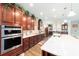 Modern kitchen features double ovens, granite countertops, and custom cabinetry at 9551 Sw 70Th Loop, Ocala, FL 34481