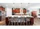Eat-in kitchen island with seating, stainless steel appliances and dark wood cabinets at 9551 Sw 70Th Loop, Ocala, FL 34481