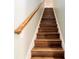 Wooden staircase with a light-colored wood handrail at 9551 Sw 70Th Loop, Ocala, FL 34481