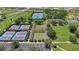 Aerial view of the community tennis courts, bocce ball courts, and surrounding green spaces at 9591 Sw 70Th Loop, Ocala, FL 34481