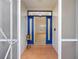 Inviting entryway with blue door and terracotta tile flooring at 9593 Sw 196Th Avenue Rd, Dunnellon, FL 34432