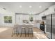 Modern white kitchen with island and stainless steel appliances at 9593 Sw 196Th Avenue Rd, Dunnellon, FL 34432