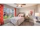 Bedroom with floral bedding, window seating, and natural light at 9988 Se 161St Lane Rd, Summerfield, FL 34491