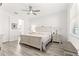 Bright bedroom with a queen bed and attached bathroom at 10589 Sw 98Th Ln, Ocala, FL 34481