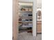 Neatly organized linen closet with shelves for storage at 10837 Sw 80Th Ct, Ocala, FL 34481