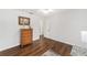 Simple bedroom with wood floors and a dresser at 185 Ne 55Th Ave, Ocala, FL 34470