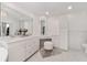 Bright bathroom with double vanity, large mirror, and white cabinets at 4841 Nw 76Th Ct, Ocala, FL 34482