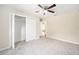 Bedroom with ceiling fan, closet, and carpeted floor at 5083 Sw Hyacinth Ct, Dunnellon, FL 34431