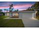 Front exterior elevation of house at dusk at 5083 Sw Hyacinth Ct, Dunnellon, FL 34431