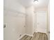 Laundry room with white door, overhead shelving, and neutral walls at 5083 Sw Hyacinth Ct, Dunnellon, FL 34431