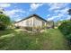 Large, grassy backyard with lush landscaping and a screened patio at 9175 Sw 65Th Loop, Ocala, FL 34481