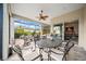 Spacious covered patio with outdoor dining area and ceiling fan at 9175 Sw 65Th Loop, Ocala, FL 34481