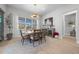 Elegant dining room with a round table, stylish chandelier, and large windows at 9175 Sw 65Th Loop, Ocala, FL 34481