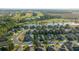 Aerial view of the community featuring a golf course and nearby lake at 9175 Sw 65Th Loop, Ocala, FL 34481