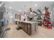 Kitchen island with white countertop, pendant lights, and view of the living room at 9175 Sw 65Th Loop, Ocala, FL 34481