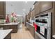 Kitchen with stainless steel appliances, wood cabinets, and a view of the dining area at 9175 Sw 65Th Loop, Ocala, FL 34481
