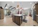 Kitchen island with pendant lights, large countertop, and view of the living room at 9175 Sw 65Th Loop, Ocala, FL 34481
