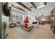 Open-concept living room with wood floors, wood beams, and view of the kitchen at 9175 Sw 65Th Loop, Ocala, FL 34481