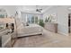 Large main bedroom with a ceiling fan, plush carpet, and an ensuite bathroom at 9175 Sw 65Th Loop, Ocala, FL 34481