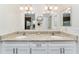 Modern bathroom with dual sinks, granite countertop, and white cabinetry at 9199 Se 135Th St, Summerfield, FL 34491