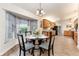 Dining area with bay window adjacent to the kitchen, featuring a round glass table and four chairs at 9199 Se 135Th St, Summerfield, FL 34491