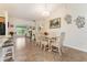 Dining area with glass-top table, white chairs, and tile flooring at 9199 Se 135Th St, Summerfield, FL 34491