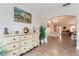 Entryway with white dresser, decorative accents, and view of the dining area at 9199 Se 135Th St, Summerfield, FL 34491