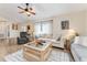 Bright and airy living room featuring a comfortable seating area, a ceiling fan, and neutral decor at 9199 Se 135Th St, Summerfield, FL 34491