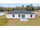 Aerial view of single-story home with backyard and patio at 10178 Sw 137 Ave, Dunnellon, FL 34432